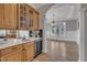 Stylish wet bar with custom cabinetry, wine refrigerator, and stone countertop at 601 Ballad Creek Ct, Cary, NC 27519