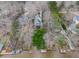 Aerial view of the home surrounded by green lawn and waterfront at 651 Sagamore Dr, Louisburg, NC 27549