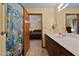 Bright bathroom with a shower, cabinet sink, and an open view into the Primary bedroom at 651 Sagamore Dr, Louisburg, NC 27549