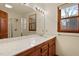 Bright bathroom featuring a wood vanity with marble countertop and a glass door shower at 651 Sagamore Dr, Louisburg, NC 27549