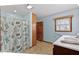 Bright bathroom with shower curtain, window, and tile floors at 651 Sagamore Dr, Louisburg, NC 27549