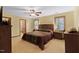 Large bedroom features neutral walls, carpet, ceiling fan, and windows with shades, creating a cozy atmosphere at 651 Sagamore Dr, Louisburg, NC 27549