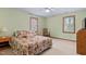 Comfortable bedroom with hardwood floors, a ceiling fan, and two large windows with light-blocking shades at 651 Sagamore Dr, Louisburg, NC 27549