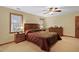 Relaxing bedroom with carpet, warm-toned walls, ceiling fan, and windows providing natural light and ventilation at 651 Sagamore Dr, Louisburg, NC 27549