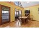 Inviting dining area with lake views, wood table, and natural light coming in from the exterior at 651 Sagamore Dr, Louisburg, NC 27549