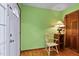 Cozy entryway featuring a white door, green walls, and hardwood floors at 651 Sagamore Dr, Louisburg, NC 27549