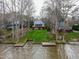 Lake house with a gently sloping yard and docks at 651 Sagamore Dr, Louisburg, NC 27549