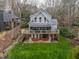 Lake house with a covered porch and open patio, surrounded by a well-maintained lawn at 651 Sagamore Dr, Louisburg, NC 27549