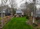 Lake house with an upper porch and lower patio, surrounded by a well-manicured lawn at 651 Sagamore Dr, Louisburg, NC 27549