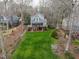 Charming lake house with two levels of outdoor deck, a lush lawn, and mature trees at 651 Sagamore Dr, Louisburg, NC 27549