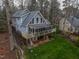 Beautiful lake house with a screened porch, open patio, and landscaped surroundings at 651 Sagamore Dr, Louisburg, NC 27549