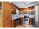 Well-lit kitchen featuring wood cabinets, stainless steel appliances, and granite countertops at 651 Sagamore Dr, Louisburg, NC 27549