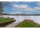 Lake view of a lakefront property with a dock and bench to enjoy the calm water view at 651 Sagamore Dr, Louisburg, NC 27549