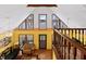 Second story view of the living room, with vaulted ceiling, ample windows, and access to an outdoor deck at 651 Sagamore Dr, Louisburg, NC 27549