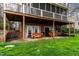 Spacious outdoor patio with seating and brick exterior and an upper screened-in porch above at 651 Sagamore Dr, Louisburg, NC 27549