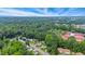 Scenic aerial view of a residential neighborhood surrounded by lush green trees and a vibrant blue sky at 6923 Fox Haven Pl, Raleigh, NC 27616