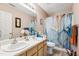 Functional bathroom featuring a double sink vanity, neutral paint color, and a shower-tub combination at 6923 Fox Haven Pl, Raleigh, NC 27616