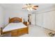 Spacious bedroom with a wood bed frame, carpeted floors, and double closets for ample storage at 6923 Fox Haven Pl, Raleigh, NC 27616