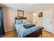 Cozy bedroom featuring a decorative bed frame, calming wall color, and a view into the bathroom at 6923 Fox Haven Pl, Raleigh, NC 27616