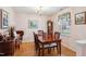 Traditional dining room with a wood table, six chairs, and natural light from the window at 6923 Fox Haven Pl, Raleigh, NC 27616