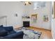 Bright living room with vaulted ceiling, fireplace, and a comfortable blue sofa on a patterned rug at 6923 Fox Haven Pl, Raleigh, NC 27616