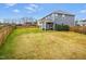 View of the large, fenced backyard featuring a lawn, patio, and the rear elevation of the home at 709 Teal Lake Dr, Holly Springs, NC 27540