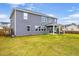 Spacious backyard with a covered patio, lawn, and fenced perimeter at 709 Teal Lake Dr, Holly Springs, NC 27540