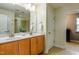 Bathroom features a double sink vanity with granite countertops, decorative lighting and a tiled shower at 709 Teal Lake Dr, Holly Springs, NC 27540