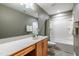 Bathroom featuring a granite countertop vanity, decorative mirror, and shower/tub combination at 709 Teal Lake Dr, Holly Springs, NC 27540