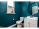 Stylish powder room featuring a sleek vanity, round mirror, and modern fixtures at 709 Teal Lake Dr, Holly Springs, NC 27540