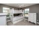 Bright bedroom features a bunk bed, two windows, and decorative accents at 709 Teal Lake Dr, Holly Springs, NC 27540