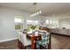 Bright dining room features stylish furniture, a modern chandelier, and natural light from large windows at 709 Teal Lake Dr, Holly Springs, NC 27540