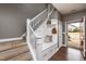 Inviting entryway with staircase, mudroom bench, and open front door at 709 Teal Lake Dr, Holly Springs, NC 27540