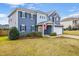 Charming two-story home featuring blue siding, a well-manicured lawn, and a two-car garage at 709 Teal Lake Dr, Holly Springs, NC 27540