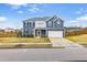 Charming two-story home showcasing curb appeal with a driveway, and a well-maintained front yard at 709 Teal Lake Dr, Holly Springs, NC 27540