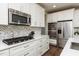 Modern kitchen with white cabinets, stainless steel appliances, and stylish backsplash at 709 Teal Lake Dr, Holly Springs, NC 27540