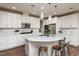 Bright, spacious kitchen with white cabinets, quartz countertops, and stainless steel appliances at 709 Teal Lake Dr, Holly Springs, NC 27540