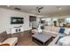 Open-concept living space featuring a large sectional sofa, TV, and seamless connection to the kitchen at 709 Teal Lake Dr, Holly Springs, NC 27540