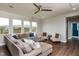 Comfortable living room with neutral tones, a large sectional sofa, and natural light streaming through multiple windows at 709 Teal Lake Dr, Holly Springs, NC 27540