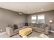 Cozy living room featuring a comfortable sectional sofa, accent chair, and projector at 709 Teal Lake Dr, Holly Springs, NC 27540