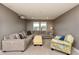 Cozy living room featuring a comfortable sectional sofa, accent chair, and projector at 709 Teal Lake Dr, Holly Springs, NC 27540