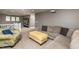 Cozy living room featuring a comfortable sectional sofa, accent chair, and open access to loft at 709 Teal Lake Dr, Holly Springs, NC 27540