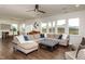 Spacious living room with a large sectional sofa, ample natural light, and open access to the dining area at 709 Teal Lake Dr, Holly Springs, NC 27540