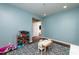 Bright room with light blue walls, blue carpet, and a table with chairs at 709 Teal Lake Dr, Holly Springs, NC 27540