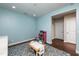 Bright room with light blue walls, blue carpet, and a table with chairs at 709 Teal Lake Dr, Holly Springs, NC 27540