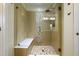 Tiled shower features glass doors, built in bench, and decorative stone accents at 709 Teal Lake Dr, Holly Springs, NC 27540