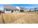 Large backyard featuring a black fence, landscaping, and a view of neighboring properties at 74 Silver Moon Ln, Clayton, NC 27527