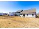 Spacious backyard with black fencing, a rear patio, landscaping, and neighborhood views at 74 Silver Moon Ln, Clayton, NC 27527