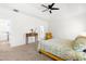 Bright bedroom with large windows, featuring a ceiling fan, and a cozy seating area near the entrance at 74 Silver Moon Ln, Clayton, NC 27527