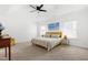 Bright bedroom featuring a ceiling fan, neutral walls, and a large window for ample natural light at 74 Silver Moon Ln, Clayton, NC 27527